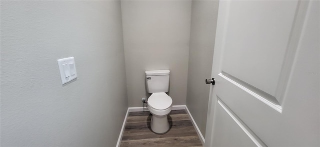 bathroom with toilet and hardwood / wood-style floors