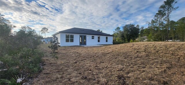 rear view of property featuring a patio area and a yard