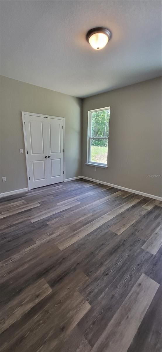 spare room featuring dark hardwood / wood-style flooring