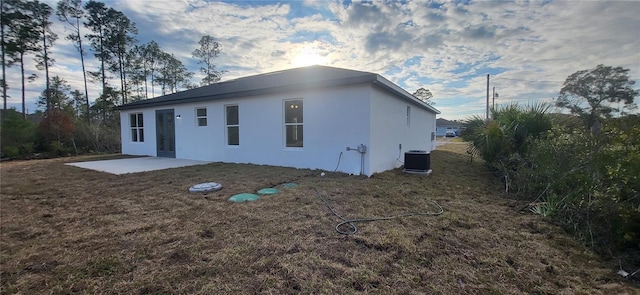 back of property with a patio area and central AC