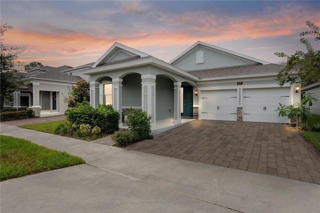 890 Terrapin Dr, Debary, FL 32713 - view of front of house with a shingled roof, an attached garage, covered porch, stucco siding, and decorative driveway