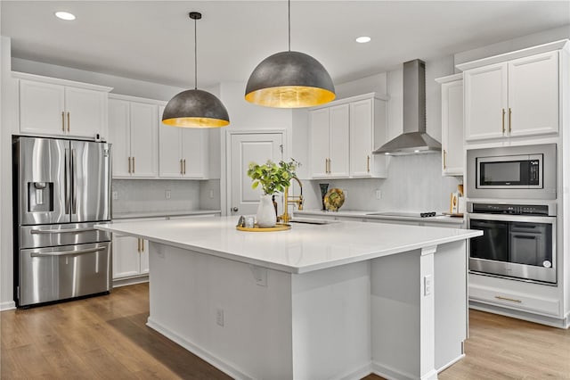 890 Terrapin Dr, Debary, FL 32713 - kitchen featuring white cabinets, a center island with sink, wall chimney exhaust hood, and appliances with stainless steel finishes