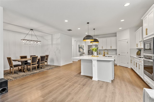 890 Terrapin Dr, Debary, FL 32713 - kitchen with visible vents, a sink, light countertops, appliances with stainless steel finishes, and recessed lighting