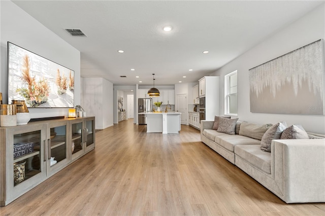 890 Terrapin Dr, Debary, FL 32713 - living area with visible vents, light wood-type flooring, and recessed lighting