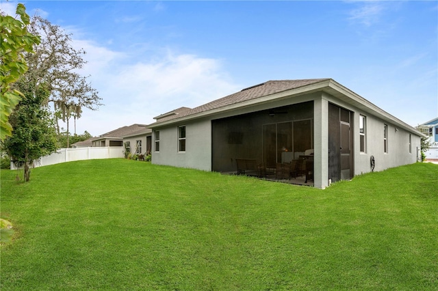 890 Terrapin Dr, Debary, FL 32713 - back of property with fence, a yard, stucco siding, and a sunroom