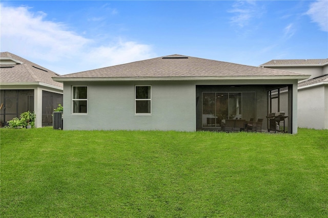 890 Terrapin Dr, Debary, FL 32713 - rear view of house featuring a yard, roof with shingles, and a sunroom