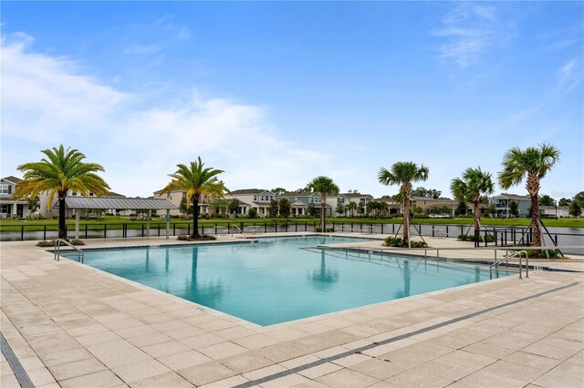890 Terrapin Dr, Debary, FL 32713 - community pool with a patio, fence, and a residential view