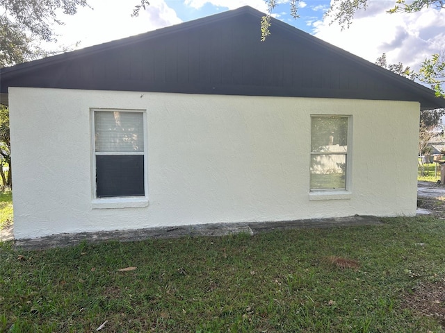 view of property exterior featuring a lawn