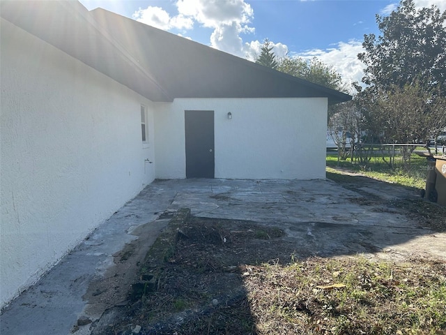 view of side of property with a patio area