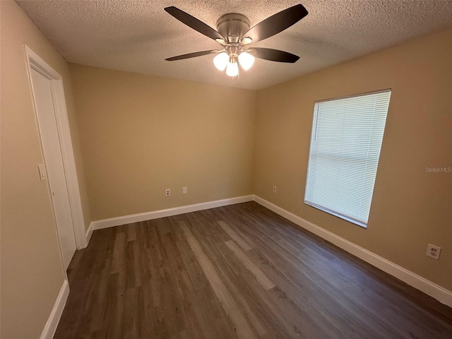 unfurnished room with ceiling fan, a textured ceiling, and dark hardwood / wood-style floors