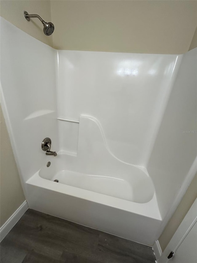 bathroom featuring  shower combination and hardwood / wood-style floors