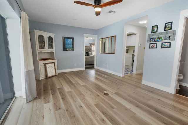 unfurnished living room with light hardwood / wood-style floors and ceiling fan