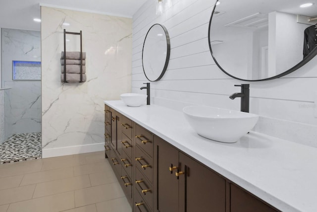 bathroom featuring vanity and tiled shower