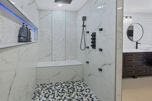 bathroom with vanity, tile walls, and a tile shower