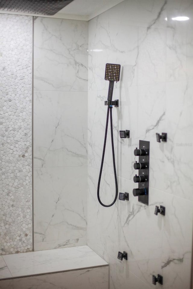 bathroom with a tile shower