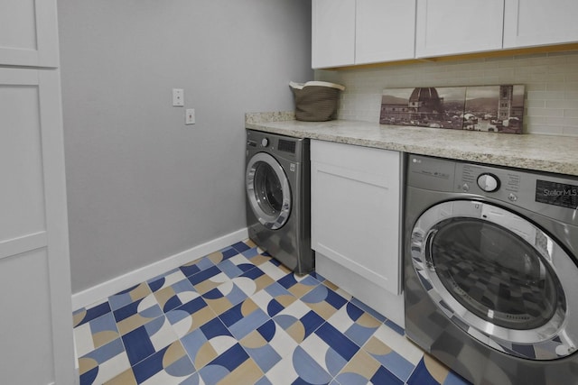 laundry area with cabinets and washing machine and dryer