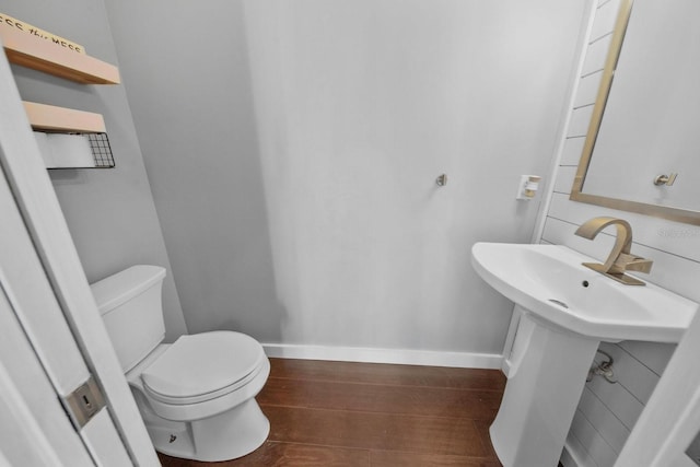 bathroom featuring wood-type flooring and toilet