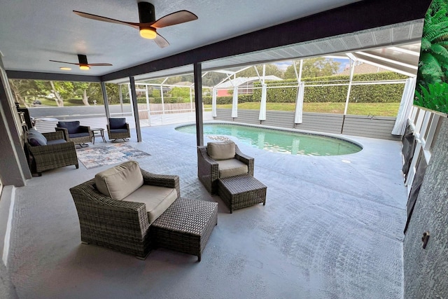 view of pool with a lanai, a patio area, outdoor lounge area, and ceiling fan