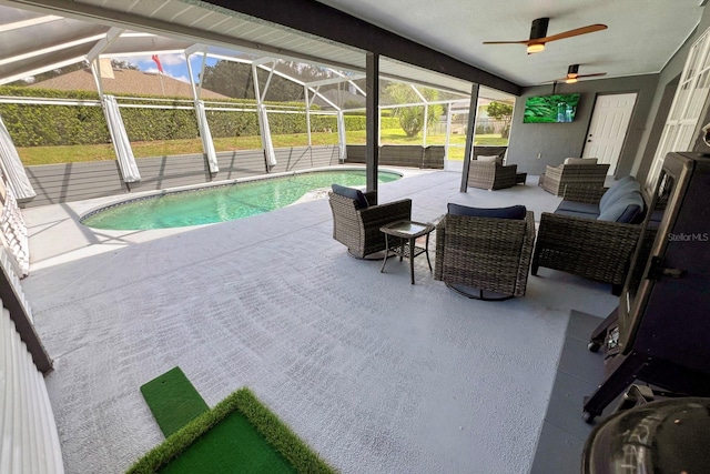 view of pool with an outdoor living space, a patio, ceiling fan, and glass enclosure