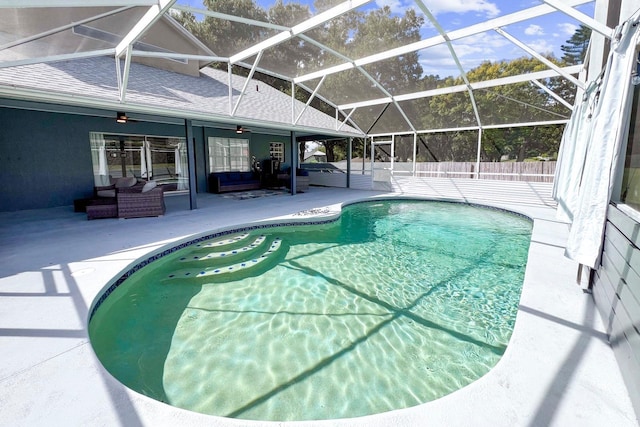 view of swimming pool with a patio, a lanai, an outdoor hangout area, and ceiling fan