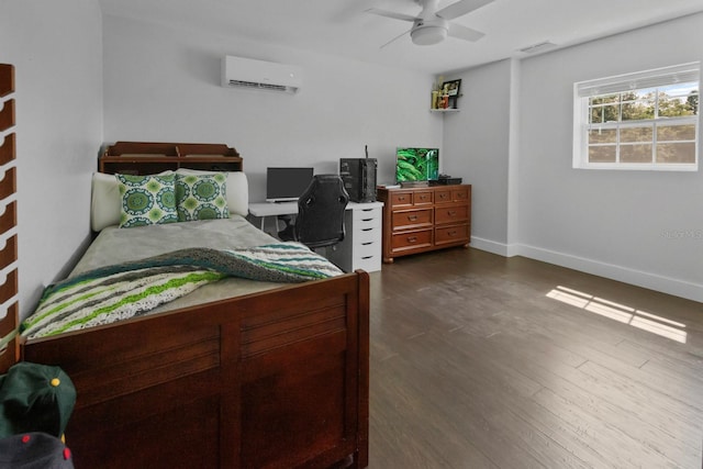 bedroom with dark hardwood / wood-style flooring, ceiling fan, and a wall mounted AC