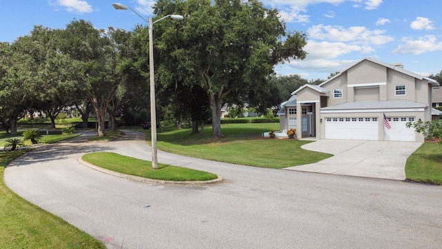 view of front facade with a garage and a front lawn