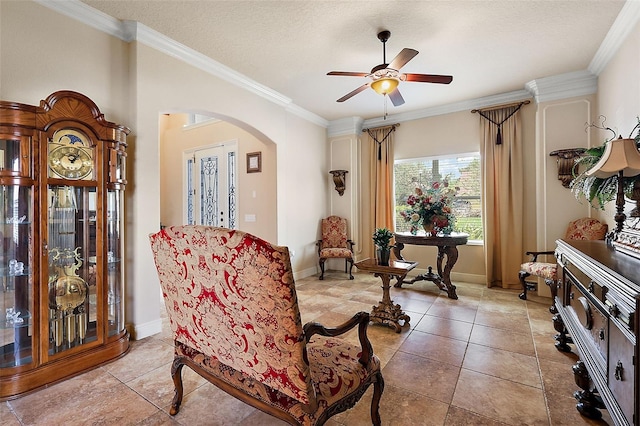 212 Crestrun Loop, Leesburg, FL 34748 - sitting room featuring arched walkways, a ceiling fan, crown molding, a textured ceiling, and tile patterned floors