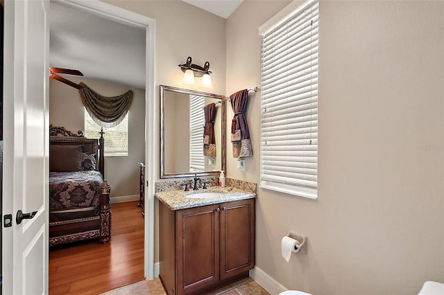 212 Crestrun Loop, Leesburg, FL 34748 - bathroom with baseboards, vanity, and connected bathroom