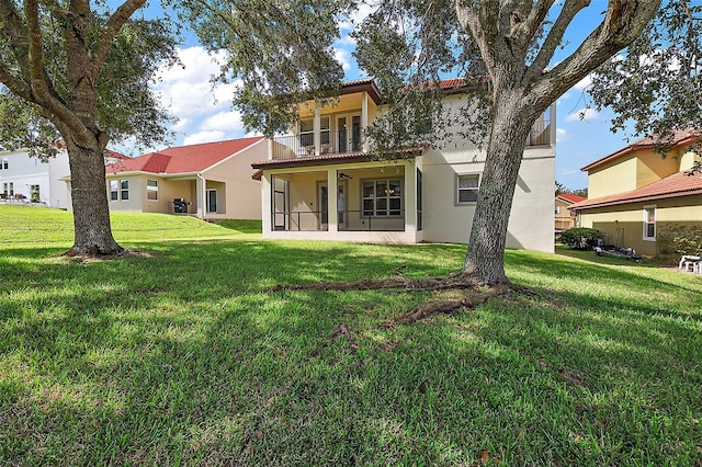 212 Crestrun Loop, Leesburg, FL 34748 - rear view of house featuring a balcony, stucco siding, a yard, and a tile roof