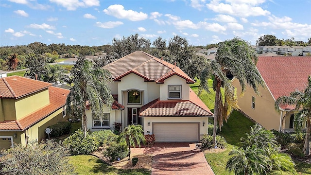 212 Crestrun Loop, Leesburg, FL 34748 - mediterranean / spanish-style home featuring a tile roof, stucco siding, decorative driveway, and a residential view