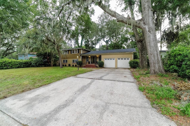 view of front of house featuring a garage and a front lawn