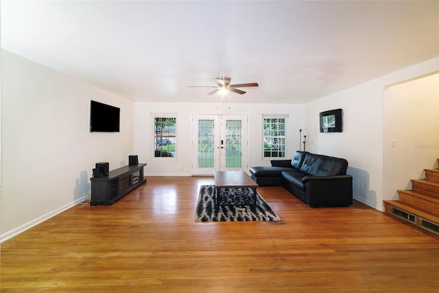 living room with french doors, hardwood / wood-style floors, and ceiling fan