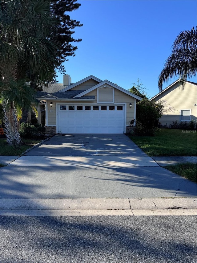 2939 Falling Tree Cir, Orlando, FL 32837 - ranch-style house featuring concrete driveway, an attached garage, a chimney, and a front lawn