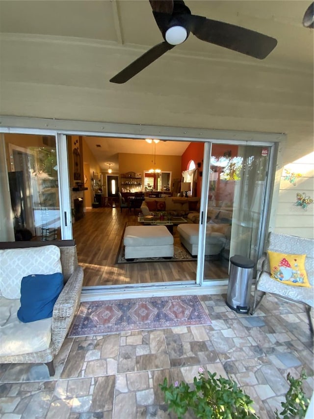 exterior space with ceiling fan with notable chandelier