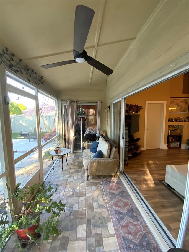 sunroom / solarium featuring ceiling fan and lofted ceiling