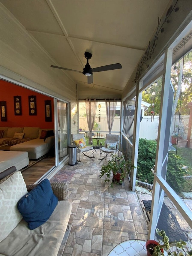 sunroom with lofted ceiling and ceiling fan