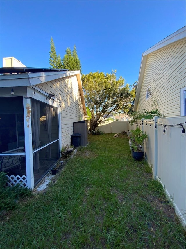 view of yard featuring a sunroom