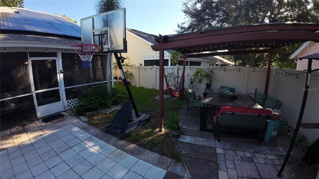 2939 Falling Tree Cir, Orlando, FL 32837 - view of patio featuring a fenced backyard, outdoor dining space, a sunroom, and a pergola