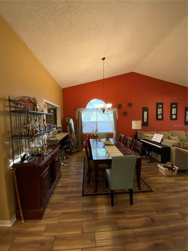 2939 Falling Tree Cir, Orlando, FL 32837 - dining room with lofted ceiling, wood finished floors, and a chandelier