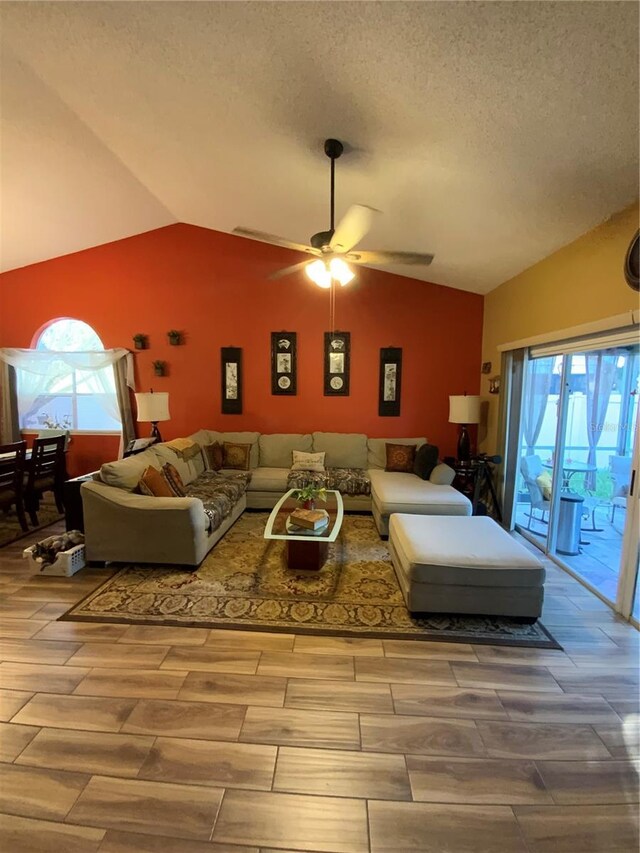 2939 Falling Tree Cir, Orlando, FL 32837 - living room with vaulted ceiling, ceiling fan, plenty of natural light, wood finished floors, and a textured ceiling
