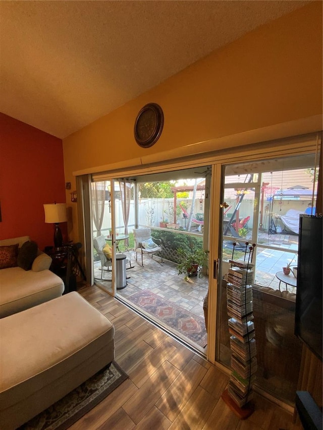 2939 Falling Tree Cir, Orlando, FL 32837 - entryway with vaulted ceiling, wood finished floors, and a textured ceiling