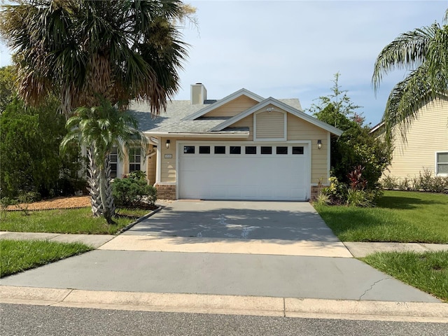 2939 Falling Tree Cir, Orlando, FL 32837 - view of front of home with concrete driveway, a garage, a chimney, and a front yard