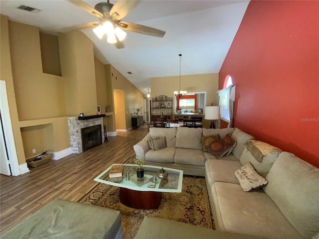 2939 Falling Tree Cir, Orlando, FL 32837 - living area with a chandelier, wood finished floors, high vaulted ceiling, ceiling fan, and a fireplace