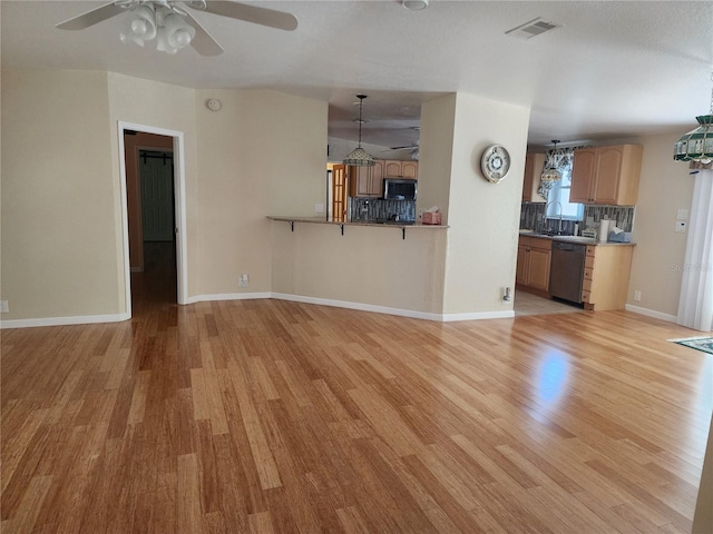 unfurnished living room with light hardwood / wood-style flooring and ceiling fan