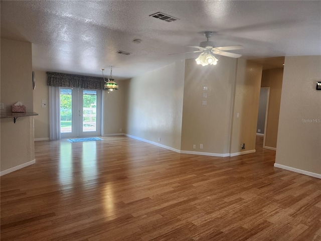 unfurnished room with a textured ceiling, hardwood / wood-style flooring, and ceiling fan