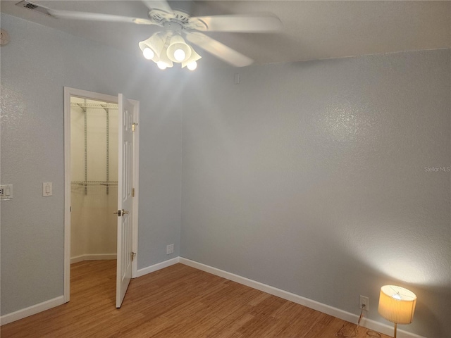 spare room featuring ceiling fan and hardwood / wood-style flooring