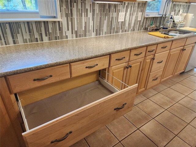14902 Arrena Rd, Winter Garden, FL 34787 - kitchen with light tile patterned floors, a sink, and light brown cabinetry