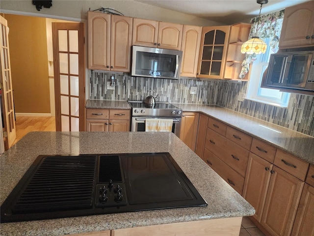 kitchen featuring tasteful backsplash, stainless steel appliances, light brown cabinetry, and pendant lighting