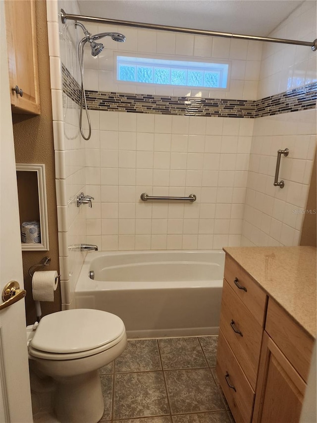 full bathroom with vanity, toilet, tile patterned floors, and tiled shower / bath