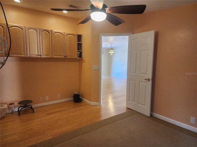 empty room featuring light hardwood / wood-style floors and ceiling fan